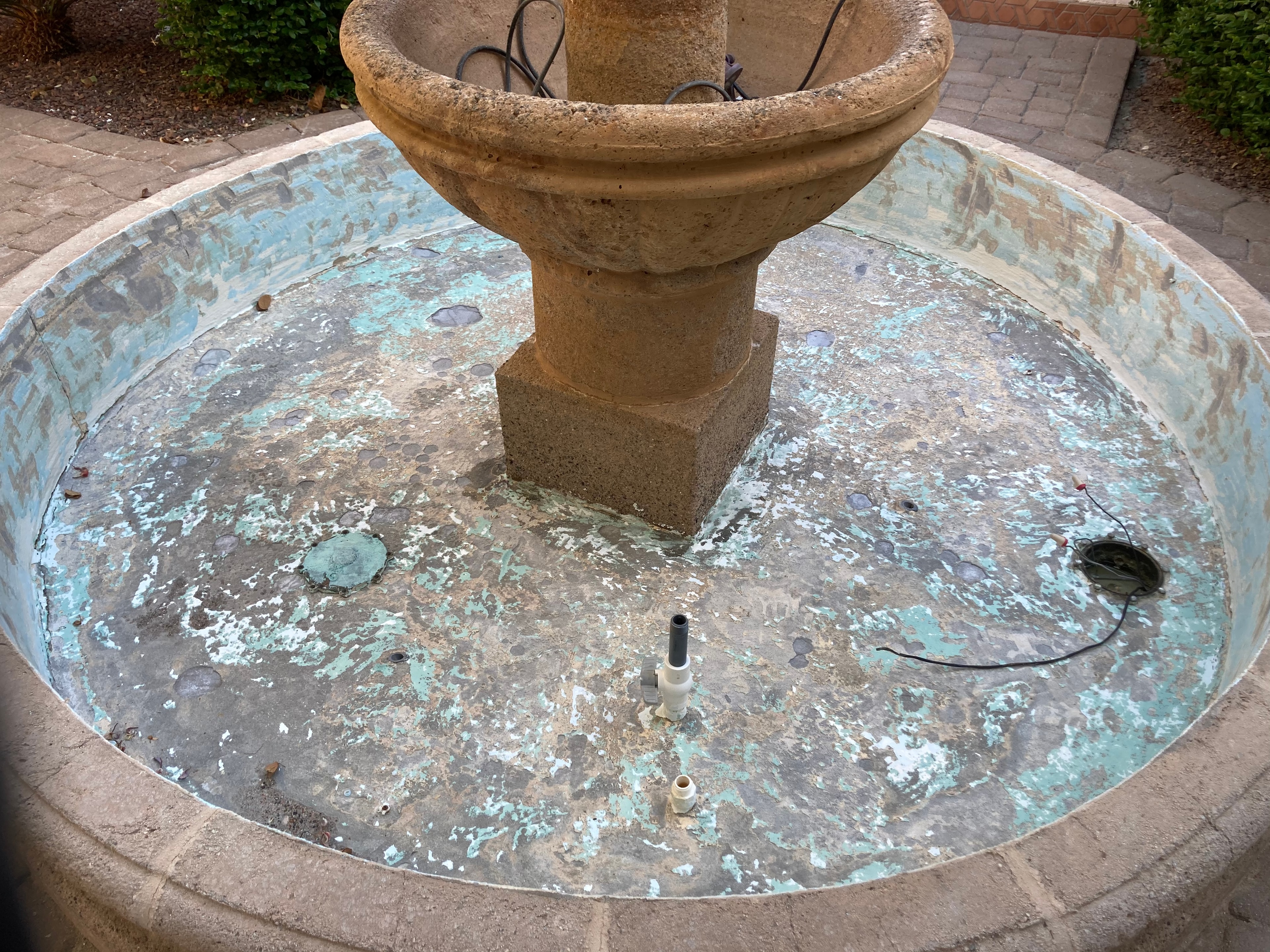 Fountain basin before resurfacing — peeling and weathered finish
